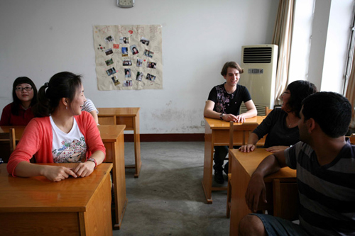 Roussillat Sebastien (third R), a 22-year-old French student at Shandong Normal University, talks to his classmates.