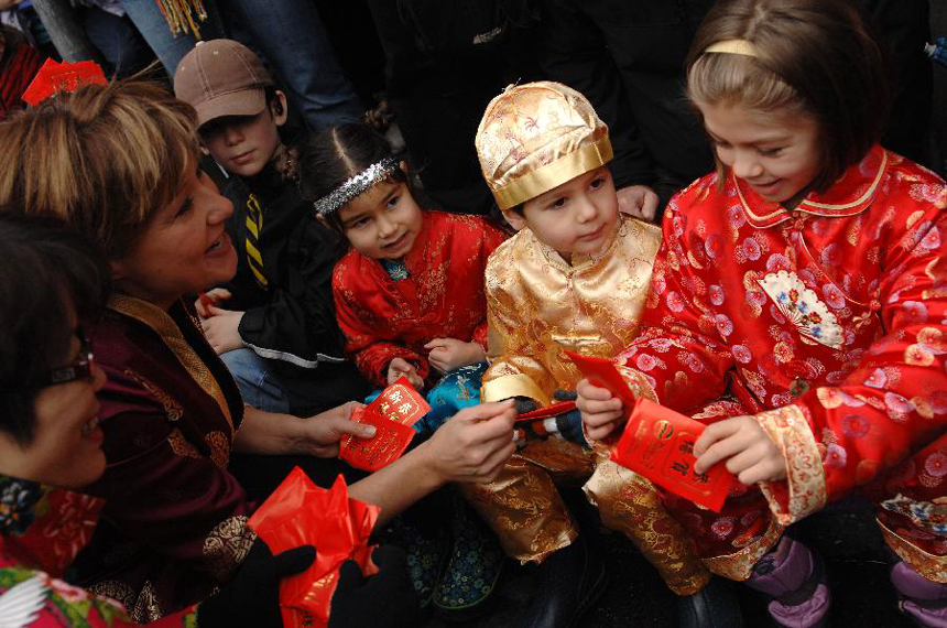 Premier of British Columbia Christy Clark (2nd L) interacts with kids during a Lunar New Year of the Snake celebration at Chinatown in Vancouver, Canada, Feb. 17, 2013. The grand parade is one of the largest in North America, drawing 70,000 people to the streets of Chinatown. 